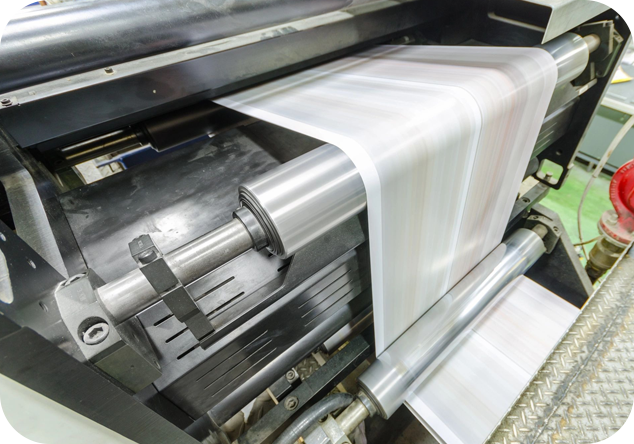 Close up of paper being rolled in a printing press.