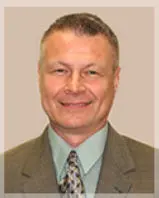 Headshot of a man in a suit.